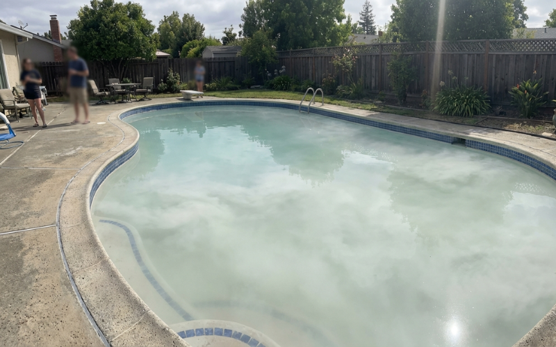 Swimming pool with milky white cloudy water caused by suspended particles