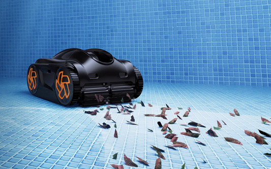 A robotic pool cleaner working in a residential in-ground pool