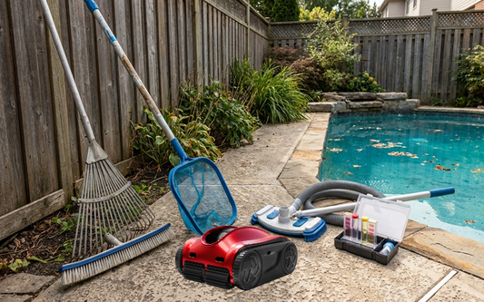 Essential pool cleaning tools arranged beside a residential swimming pool.